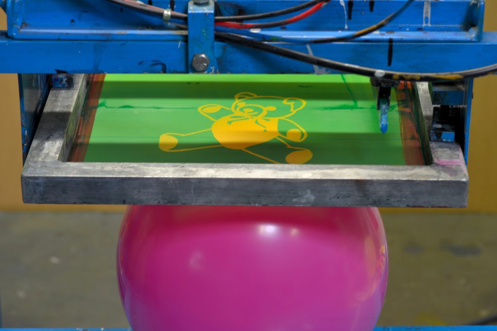 Printing on pink balloon with silk screen