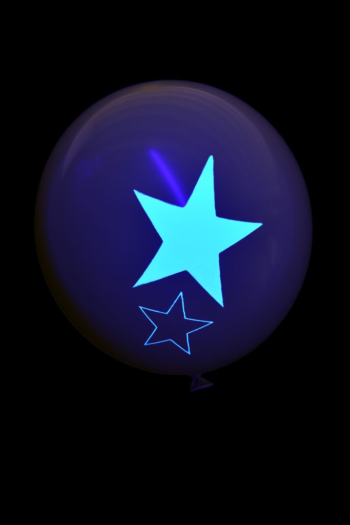 blue Fluorescent star print on balloons under UV light